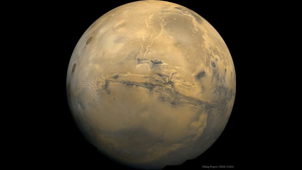 A huge canyon can be seen on the face of Mars.